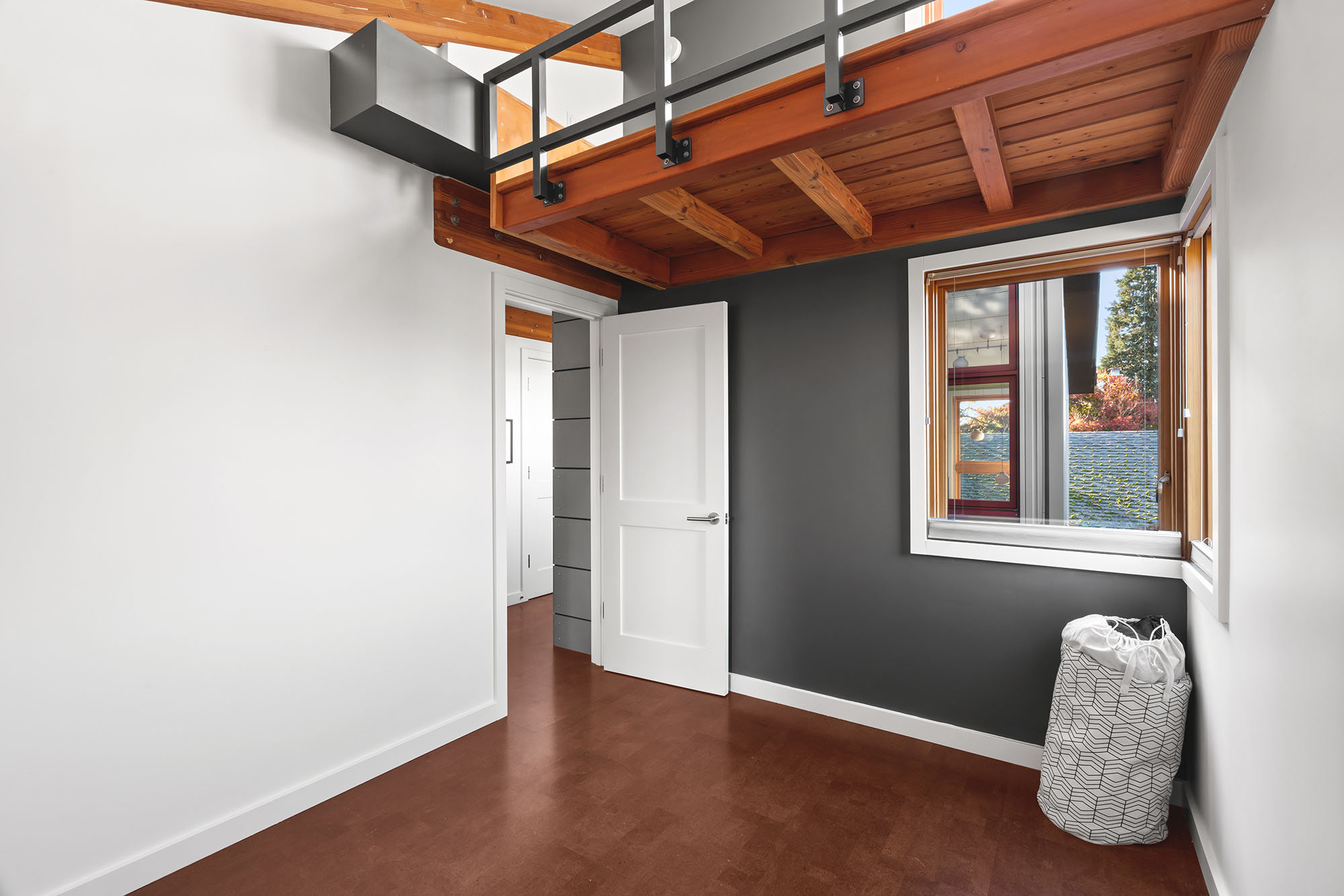Bedroom with lofted ceiling and exposed wood structure
