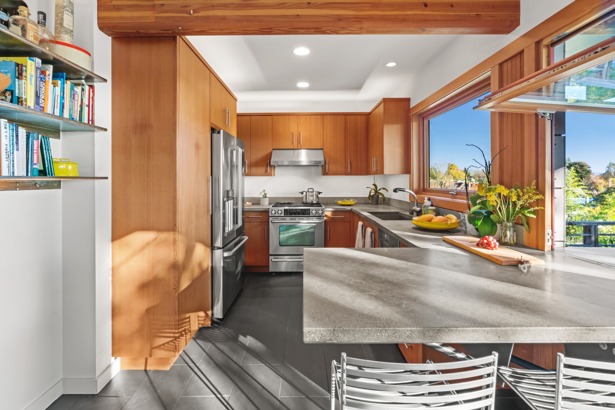 Kitchen with wood cabinetry and large window