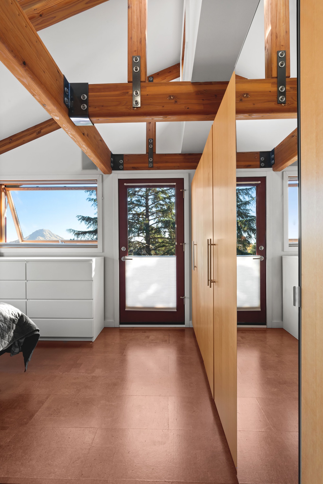 Upper floor bedroom with exposed structure and views